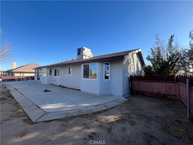 rear view of house featuring cooling unit and a patio