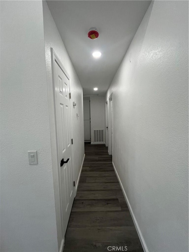 hallway with dark hardwood / wood-style flooring