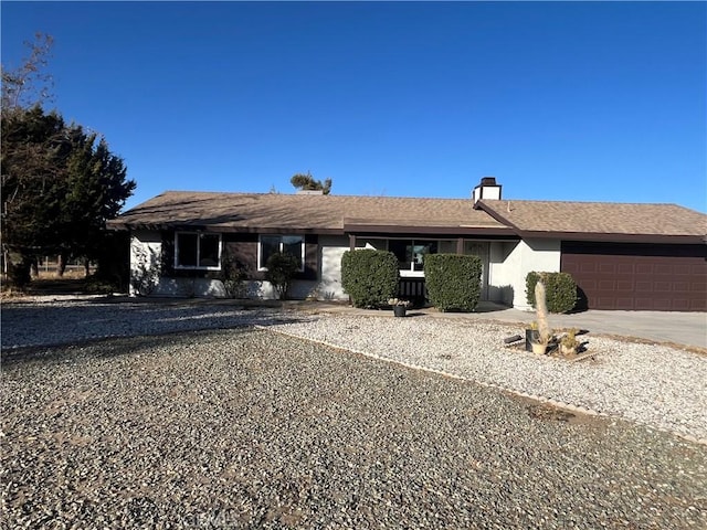 ranch-style home featuring a garage