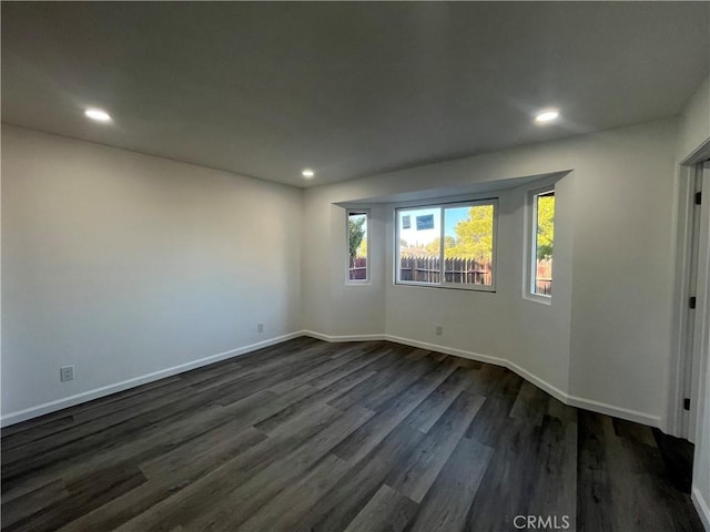 empty room featuring dark wood-type flooring