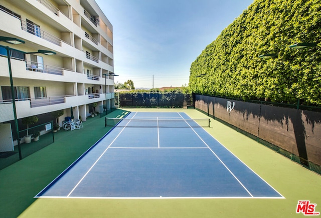 view of sport court with basketball hoop