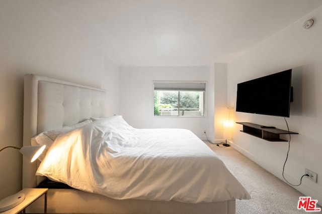 bedroom featuring light carpet