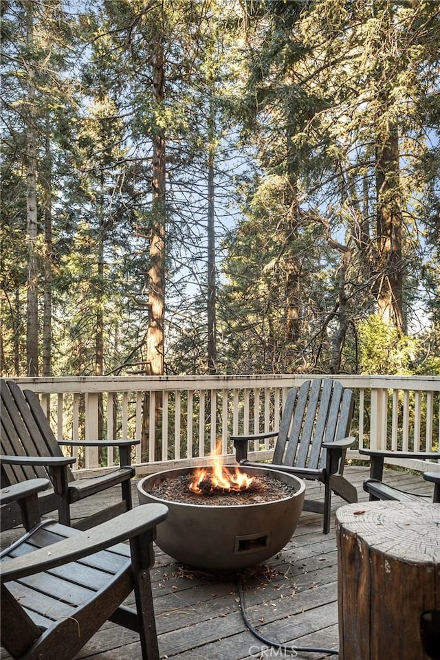 wooden deck with a fire pit