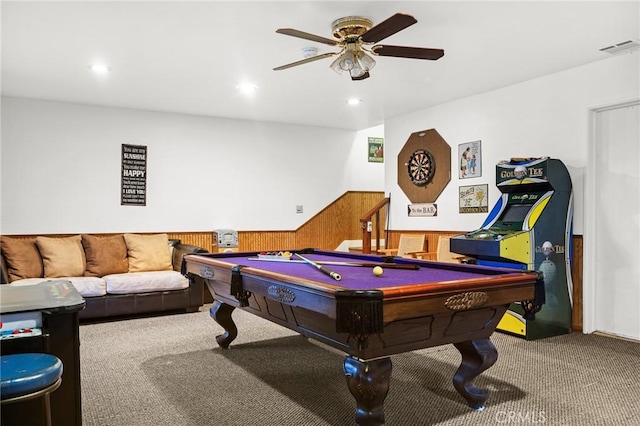 playroom featuring ceiling fan, carpet flooring, and wood walls