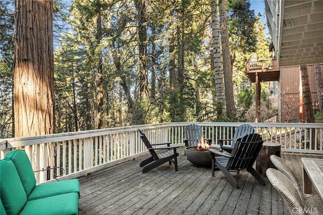 wooden deck with an outdoor fire pit