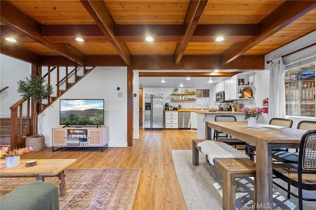 dining space featuring wooden ceiling, beamed ceiling, and light wood-type flooring