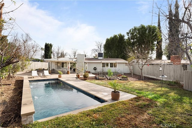 back of house featuring a lawn, central AC, a patio area, and a fenced in pool