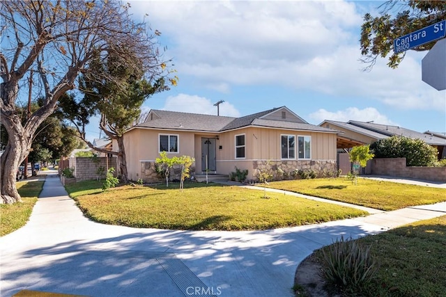 ranch-style home featuring a front yard