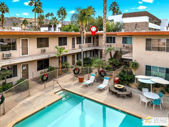 view of pool featuring a mountain view and a patio area