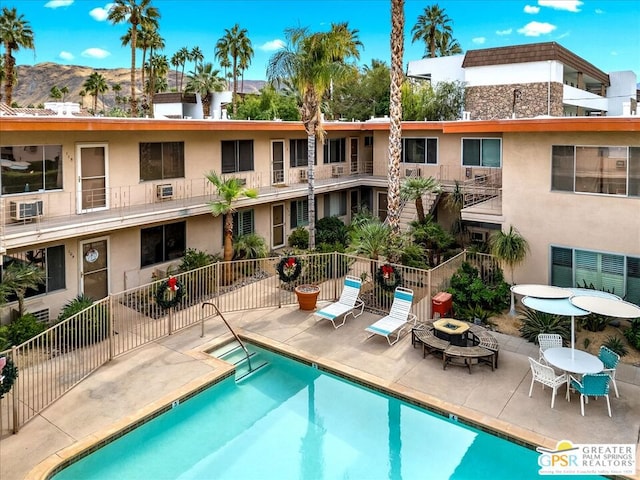 view of swimming pool featuring a mountain view and a patio area