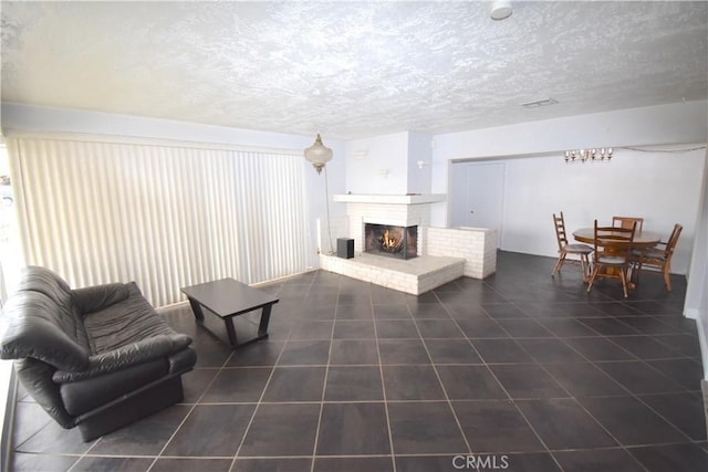 living room featuring a fireplace and a textured ceiling