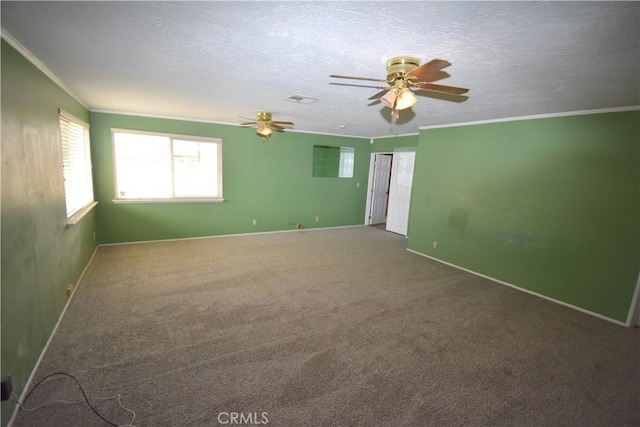 spare room featuring crown molding, carpet flooring, a textured ceiling, and ceiling fan