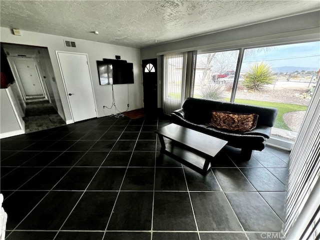 unfurnished living room featuring a textured ceiling