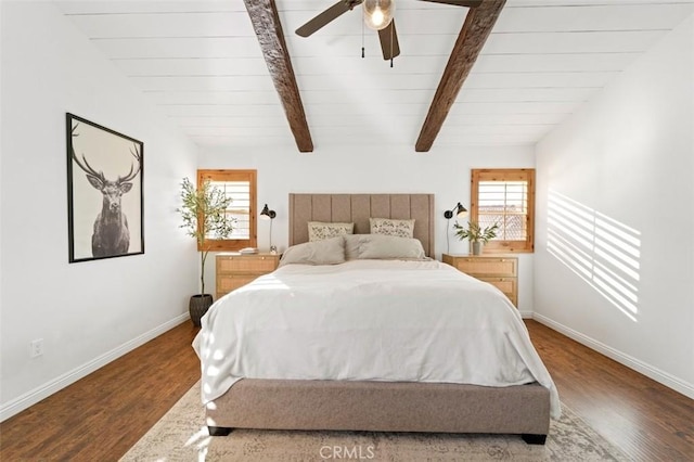 bedroom featuring hardwood / wood-style flooring, ceiling fan, and vaulted ceiling with beams