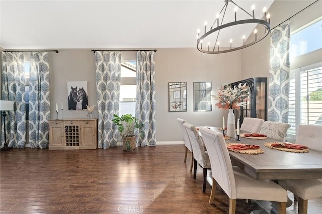 dining space with a notable chandelier and dark hardwood / wood-style floors