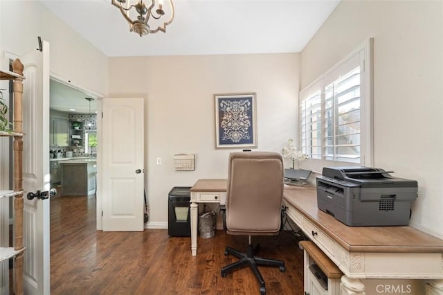 office area with dark wood-type flooring and a chandelier