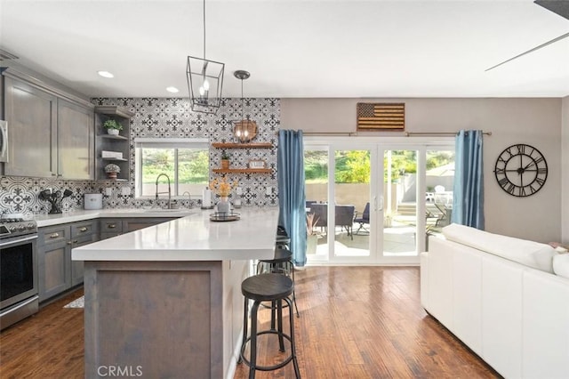 kitchen featuring pendant lighting, tasteful backsplash, plenty of natural light, and appliances with stainless steel finishes