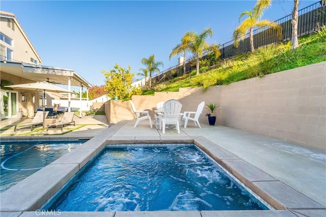 view of pool with a patio area and a jacuzzi