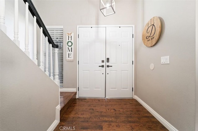 entryway with dark hardwood / wood-style flooring