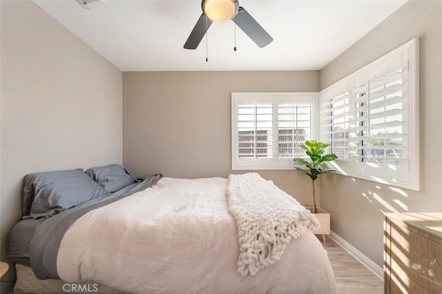 bedroom with ceiling fan and light hardwood / wood-style flooring