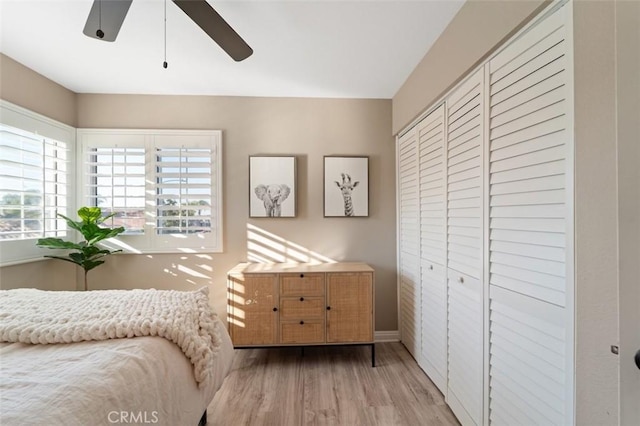 bedroom featuring hardwood / wood-style floors, ceiling fan, and a closet