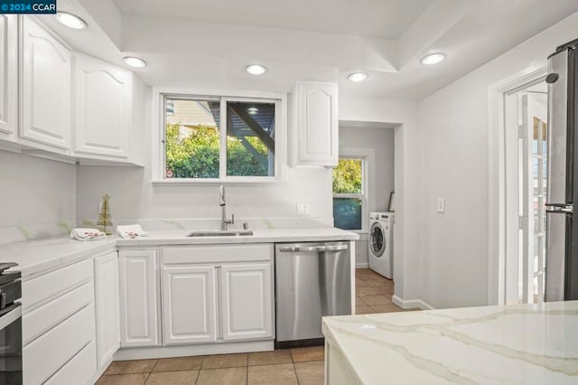 kitchen featuring light tile patterned floors, sink, white cabinets, and appliances with stainless steel finishes