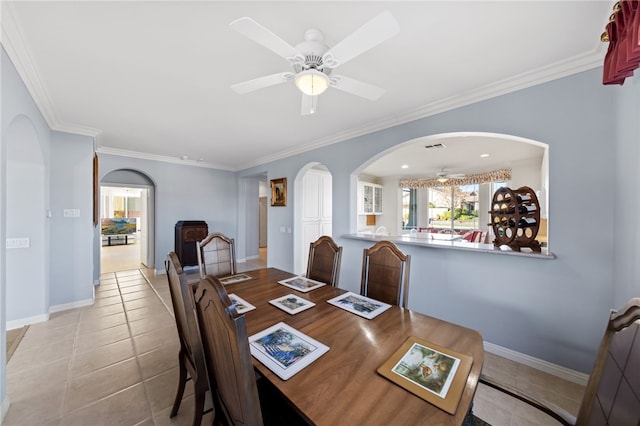 dining space featuring ceiling fan, light tile patterned floors, and ornamental molding