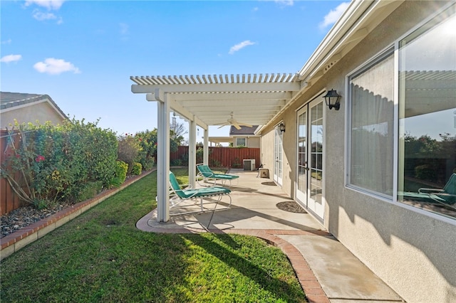 view of yard featuring central AC, a pergola, a patio, and ceiling fan