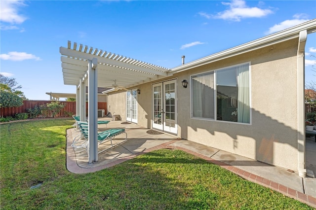 rear view of property featuring a lawn, french doors, a pergola, ceiling fan, and a patio area