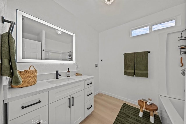 bathroom featuring vanity, a shower, and wood-type flooring