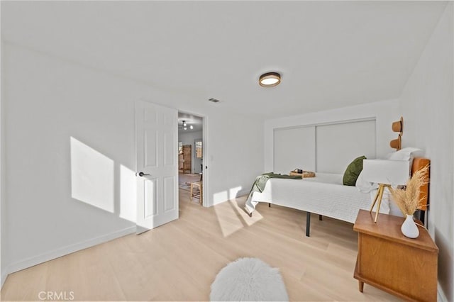 bedroom featuring hardwood / wood-style floors and a closet