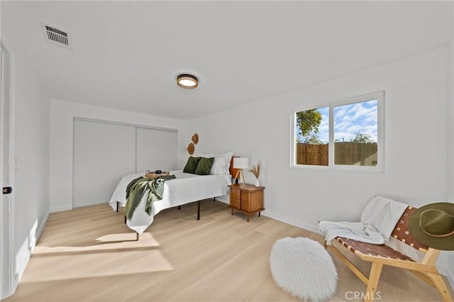 bedroom featuring wood-type flooring and a closet