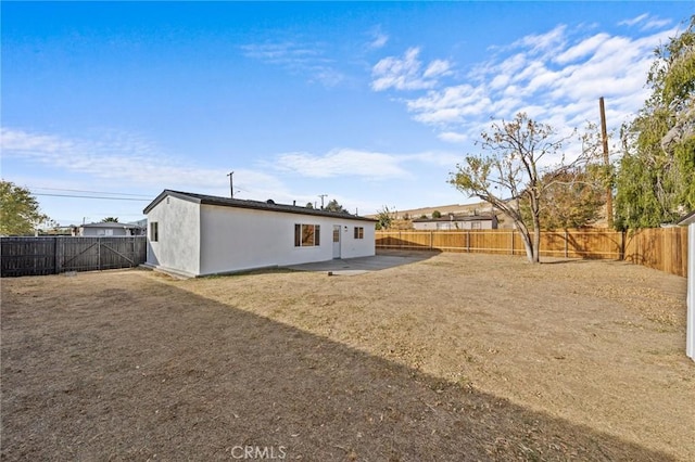 rear view of property featuring a patio