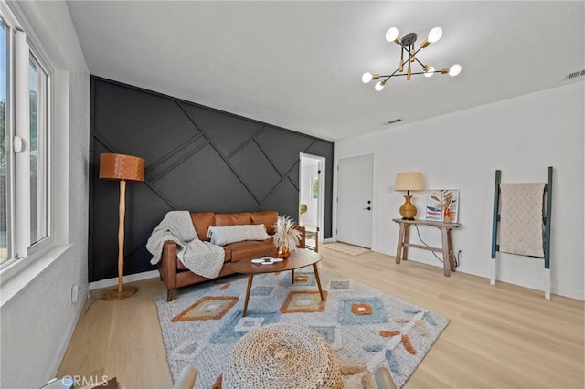 living room with a chandelier, a wealth of natural light, and wood-type flooring