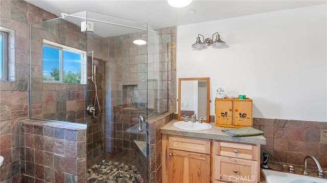 bathroom with vanity and independent shower and bath