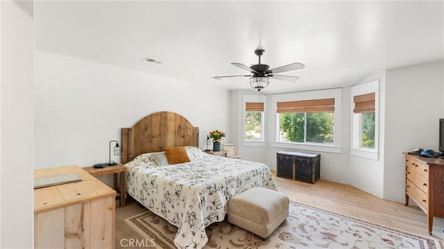 bedroom with light hardwood / wood-style floors and ceiling fan