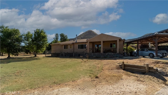 exterior space featuring a yard and a carport