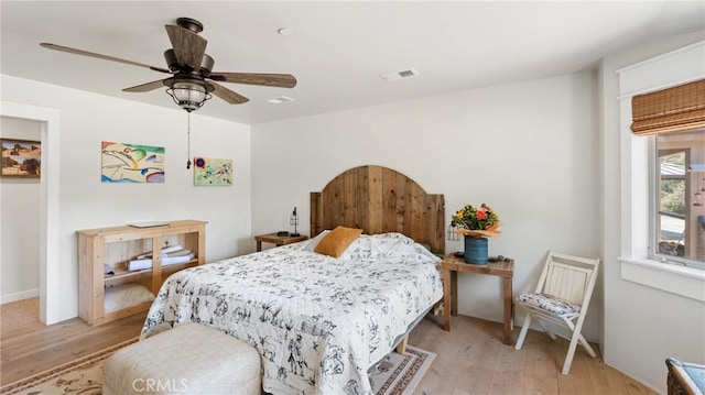 bedroom with ceiling fan and light hardwood / wood-style flooring