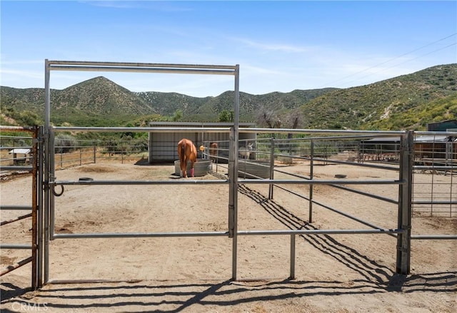 view of stable with a mountain view and a rural view