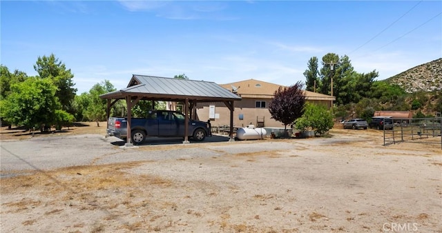 view of parking / parking lot featuring a carport