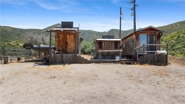 view of front of house featuring a mountain view and an outbuilding