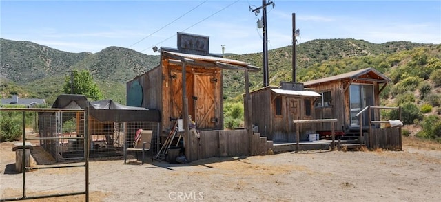 exterior space featuring an outbuilding and a mountain view