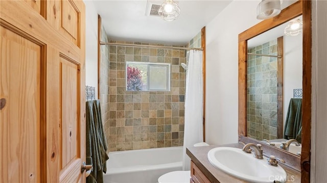 full bathroom featuring shower / tub combo, vanity, and toilet