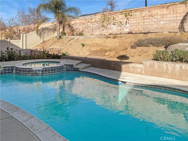 view of pool with an in ground hot tub, a fenced backyard, and a fenced in pool