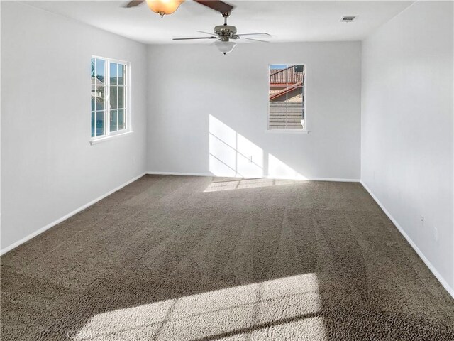 unfurnished room featuring ceiling fan and carpet floors