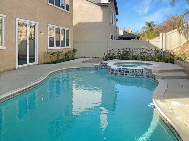 view of swimming pool with an in ground hot tub and a patio