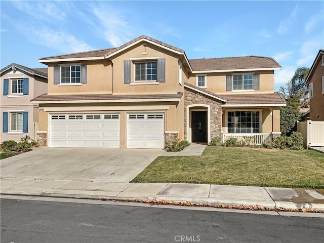 view of property with a front yard and a garage