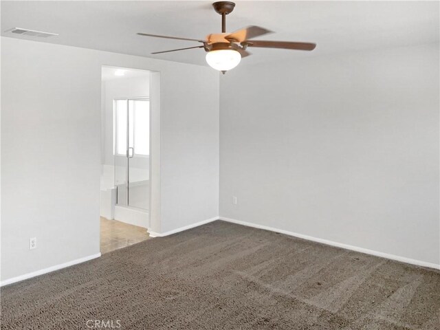 carpeted empty room featuring ceiling fan