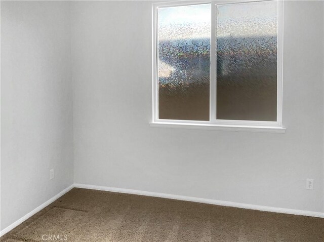 carpeted empty room with plenty of natural light