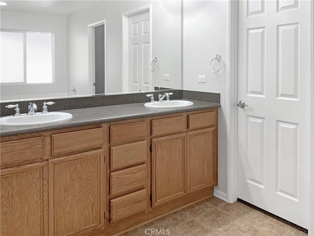 bathroom with double vanity, a sink, and tile patterned floors